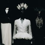 a black and white photo of mannequins and dresses
