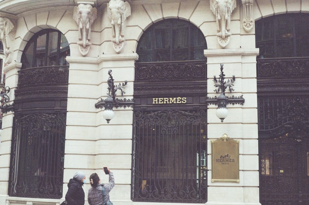 A couple of people that are standing in front of a building