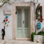 A unique door decorated with whimsical art.