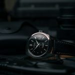 black and silver round analog watch