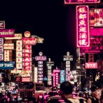 people walking along road filled with LED signages